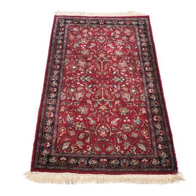 RED SCULPTED PERSIAN RUG | 20th century, red field and dark red and blue border - w. 36 x l. 64 in.