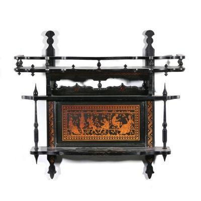 "BLACK PAINTED WALL SHELF | Two tiered wall shelf, the upper section with three quarter gallery, with spindles below, having applied...
