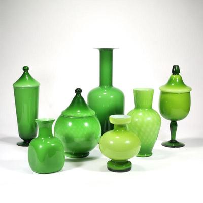 "(7pc) OTTO BRAUER GREEN GLASS GROUP | Comprising: four open vases and three lidded jars
h. 17.25 x dia. 6.5 in. (tallest)"