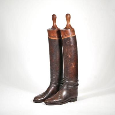 "RIDING BOOTS & BOOT FORMS | A pair of dark brown leather riding boots and wooden boot forms
h. 26 x l. 11 in. (overall)"
