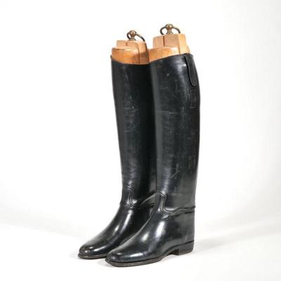 "BLACK RIDING BOOTS & BOOT FORMS | A pair of lady's black riding boots and wooden boot forms with brass bail handles
h. 19...