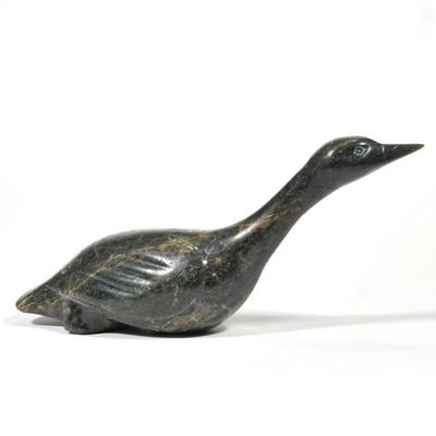 "JIMMY E. PETOOLOOSIE INUIT CARVED GREEN STONE BIRD | A stone carved bird signed by J.E. Petooloosie
h. 4 x w. 3 x l. 10 in."