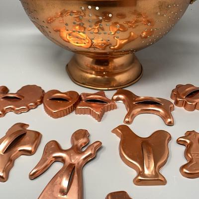 Copper Colored Cookie Cutters And A Colander 