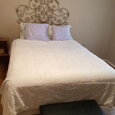 Queen bed with iron wall hanging