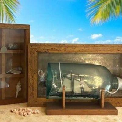 Boat in a bottle and shadow boxes of seashells