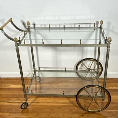 Brass Bar Cart | Hollywood Regency style silvered brass drinks cart with acorn finials, with two glass shelves. - h. 33.5 x w. 21 x l. 42...