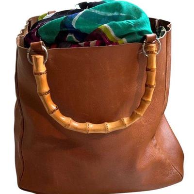 Barney s new york leather tote filled with colorful shawls