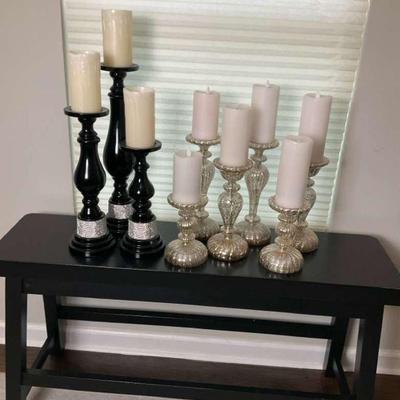 Table with decorative candle holders with pillar candles