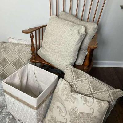 Wooden chair with decorative pillows and fabric storage box