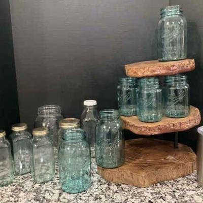 Collection of vintage ball jars with rustic wood stand and yeti