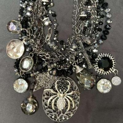 Statement necklace with black and silver charms