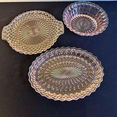 three vintage glass serving items, two pink one yellow