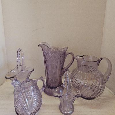 Collection Of Purple Glass Pitchers And Baskets