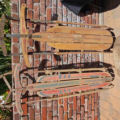 TWO VINTAGE WOODEN SLEDS AND RUSTIC WOOD FOOT STOOL 
