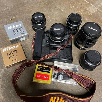 Vintage Nikon Camera Body with Multiple Lenses and Accessories
