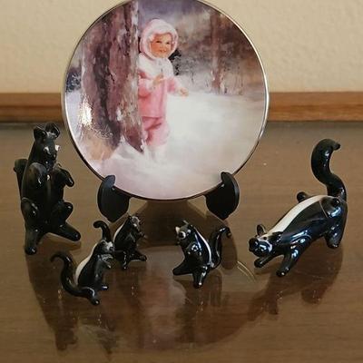Collection of Hand-Blown Glass Skunk Figurines and Miniature 'Snowy Adventure' Collector Plate