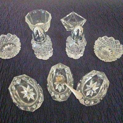 7 Assorted Crystal Salt Sellers and A Pair Of Salt And Pepper Shakers