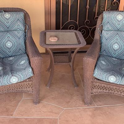 Patio Chairs And A Small Glass Table