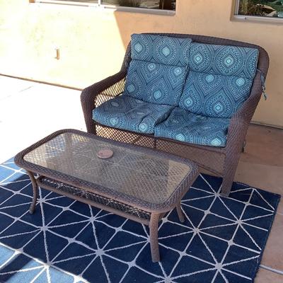 Glass Table And Blue Outdoor Couch 