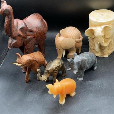 Variety of Elephant figurines including hand carved wood, brass, yellow jade and gemstones
