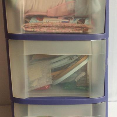 Three Drawer Storage Container With Fabric, Needlework Supplies, And Rolls Of Ribbon