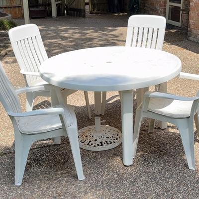 White Plastic Table , Four Chairs, Umbrella Stand 