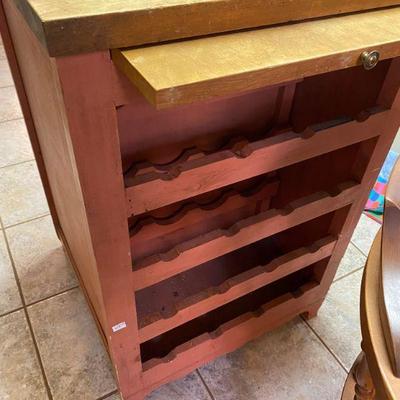kitchen island back side with wine rack and cutting board