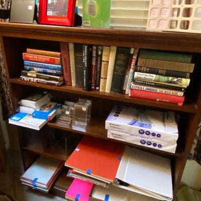 mahogany book shelf loaded with books and office supplies