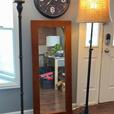 A Honey Brown Talk Mirror With A Large Plastic Clock And 2 Floor Lamps 