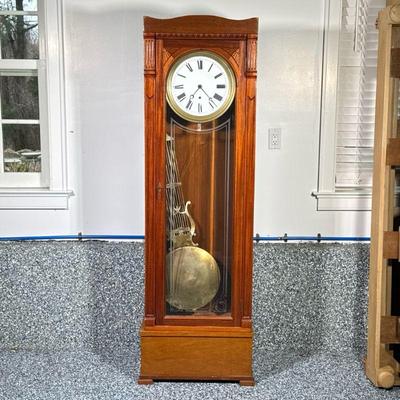 TALL CASE CLOCK | Contemporary tall case clock on base with large pendulum. Dimensions: h. 72 x w. 23 x d. 10 in
