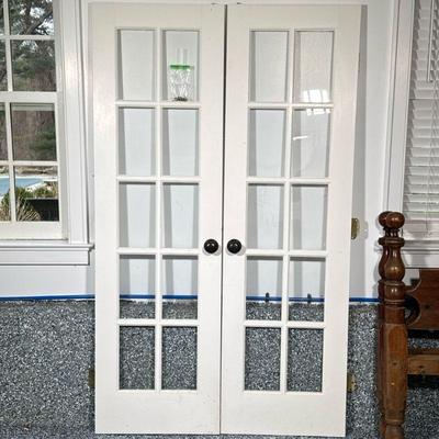 (2pc) PAIR WOOD & GLASS DOORS | Pair of white painted wood & glass doors with slide lock. Dimensions: h. 80 x w. 24 x d. 1.5 in
