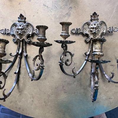 (2pc) PAIR WALL SCONCES | With lion's face backings, having three scrolled arms each with single candlestick holder.
