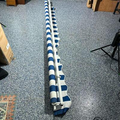 Retractable Awning, Blue & White Stripe | Retractable blue and white striped awning. Per owner purchased at Wayfair. Hand cranks...