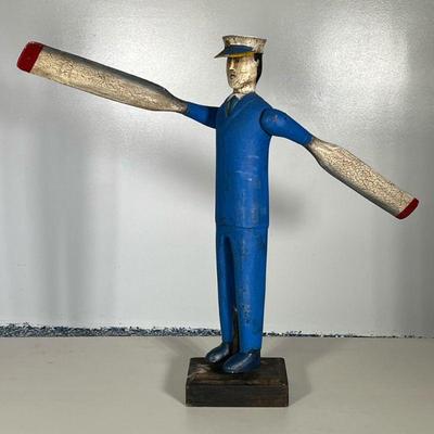 Wooden Captain Whirligig | Boat Captain dressed in blue windmill holding paddles that rotate with wind gusts, on wooden base

