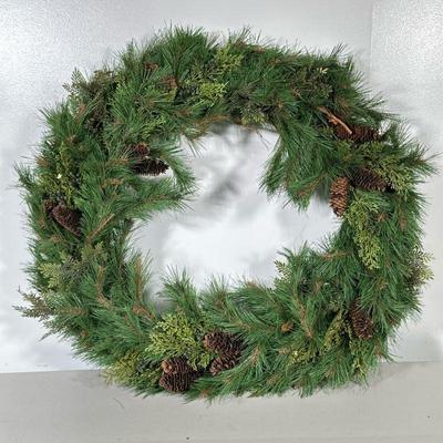 FAUX PINE WREATH | Faux Christmas wreath decorated with pine cones on metal rim. Dimensions: dia. 28 in