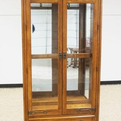 1226	PULASKI OAK 2 DOOR CRYSTAL CABINET WITH LOWER DRAWER AND BEVELED GLASS DOORS WITH SLAG AND ICED GLASS TOP, ADJUSTABLE SHELVES WITH...