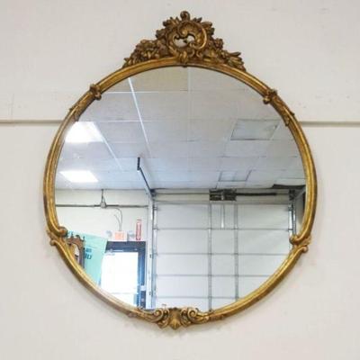 1215	ORNATE GILT EDGE ROUND HANGING MIRROR WITH SCROLLED FLORAL CREST, APPROXIMATELY 30 IN X 36 IN
