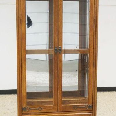 1225	PULASKI OAK 2 DOOR CRYSTAL CABINET WITH LOWER DRAWER AND BEVELED GLASS DOORS WITH SLAG AND ICED GLASS TOP, ADJUSTABLE SHELVES WITH...
