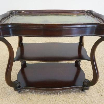 1199	MAHOGANY SERVING CART WITH GREEN LEATHER TOP AND WHEELS, SOME WEAR TO LEATHER TOP, APPROXIMATELY 39 IN X 22 IN X 32 IN H
