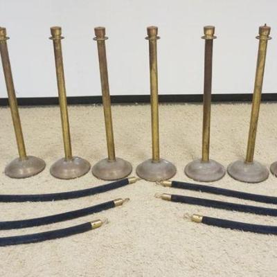 1212	GROUP OF 7 BRASS SHEATHED STANCHIONS, EACH APPROXIMATELY 41 IN H X 12 IN ROUND BASE, BARRIER LENGTH AVERAGE 48 IN
