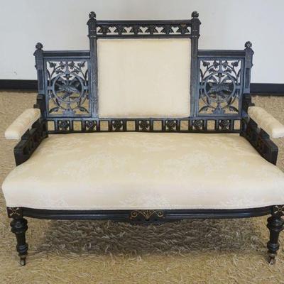 1189	ORNATE EASTLAKE VICTORIAN UPHOLSTERED PARLOR SETTEE WITH FRETWORK CUT OUT IMAGES OF BIRDS IN FLIGHT AND LEAVES, IN EBONIZED FINISH,...
