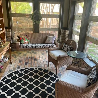 Wicker porch swing and two wicker chairs