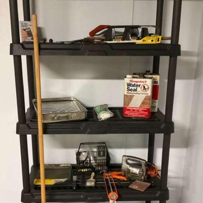 Plastic shelving unit with power tools and supplies