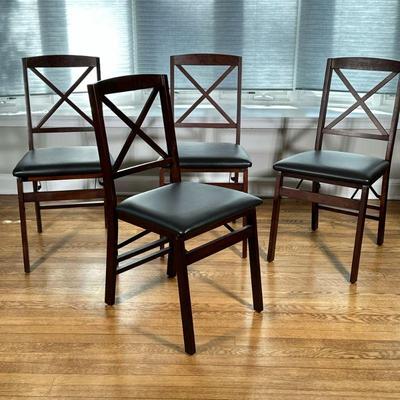 (4pc) WOOD FOLDING SIDE CHAIRS | Having black faux leather cushioned seats with dark wood frames Dimensions: h. 34 x w. 16.5 x d. 17.5 in
