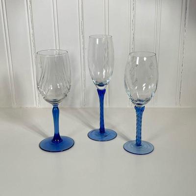 (3pc) Blue Stemmed Flutes | Three individual champagne flutes, two with twisted stems. Dimensions: h. 9 in (Tallest)
