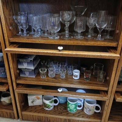 Bannister cabinet with with 3  lift-up glass doors. Dimensions 37.5"h x 24"w x 10"d. Asking $25 for cabinet. Contents sold...