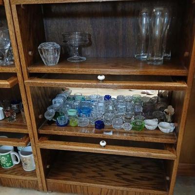 Bannister cabinet with with 3  lift-up glass doors. Dimensions 37.5"h x 24"w x 10"d. Asking $25 for cabinet. Contents sold...