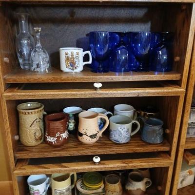 Bannister cabinet with with 3  lift-up glass doors. Dimensions 37.5"h x 24"w x 10"d. Asking $25 for cabinet. Contents sold...