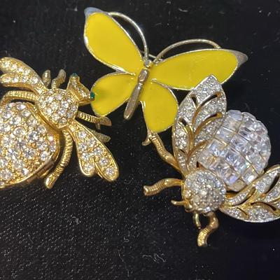 2 Bee Broaches With A Butterfly Broach
