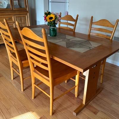 The table includes six chairs and two leaves
